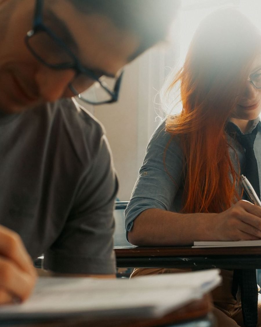 Candidates focused on their exam preparation at a desk